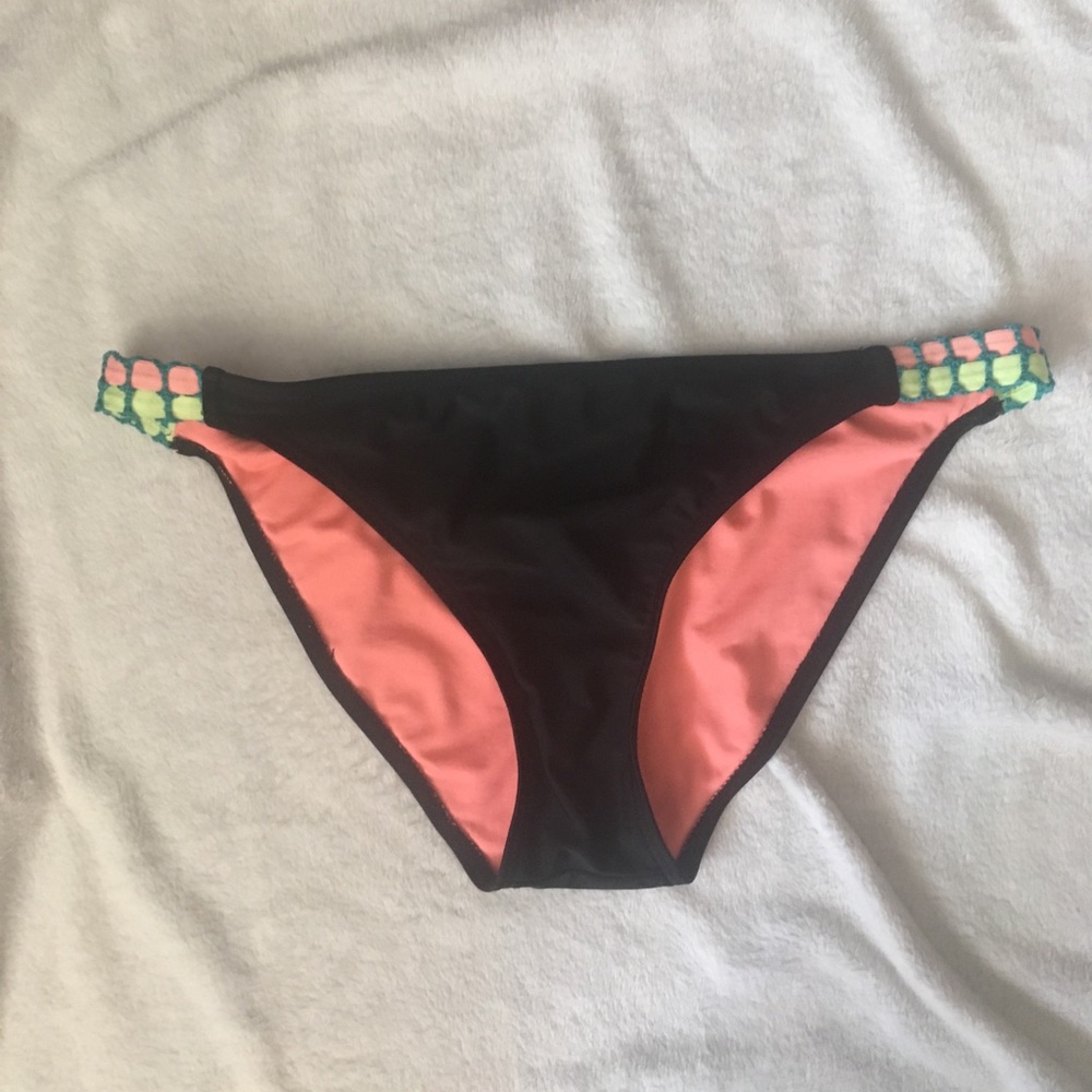 Black swimsuit bottoms with neon crochet detailing